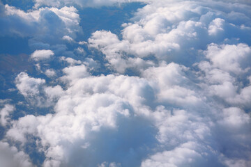 Naklejka na ściany i meble Clouds and sky as seen through window of an aircraft during flight