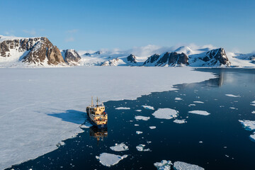 Drone shot of a ship in a bay in Svalbard
