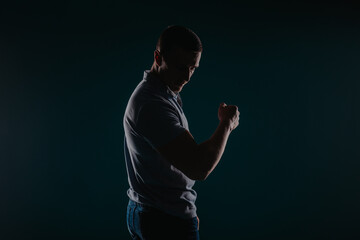 Handsome and muscular man flexing his bicep