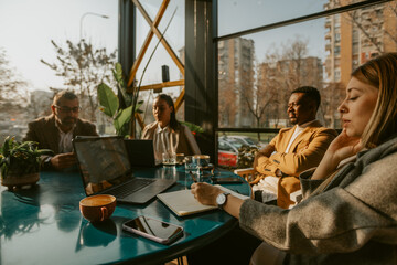 Blonde business woman talking to her colleagues