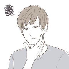 顎を触りながら顔に悩みを抱える若い男性