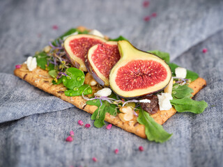 Fresh figs with green leaves on toast