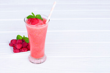 Raspberry smoothie red colorful fruit juice milkshake blend beverage healthy high protein the taste yummy In glass drink episode morning on white wood background from top view.