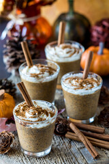 Pumpkin spice chia latte puddings garnished with cinnamon sticks.