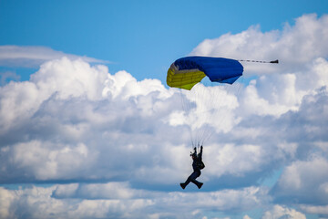 Parachute in the sky. Skydiver is flying a parachute in the blue sky