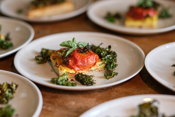 Tasty vegetarian flatbread pieces with broccoli on plates