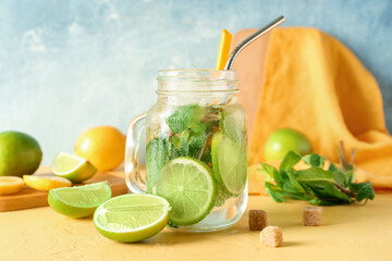 Mason jar of tasty mojito on table