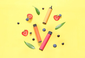 Electronic cigarette with berries on yellow background