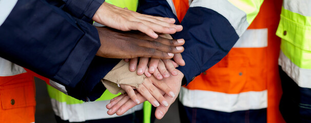 Closeup group of engineer team harmonious with hands stack for goal and success at factory...