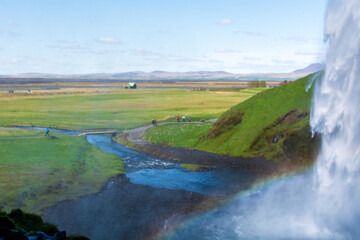 Seljalandsfoss Waterfall - People walking towards the waterfall in Iceland	
