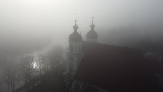 Aerial footage of the Church of the Discovery of the Holy Cross in Vilnius, Lithuania with hazy sky