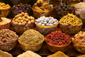 Closeup of an assortment of dried fruits and vegetables and spices for sale
