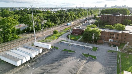 Aerial view of a residential neighborhood surrounded by lush greenery on a sunny day