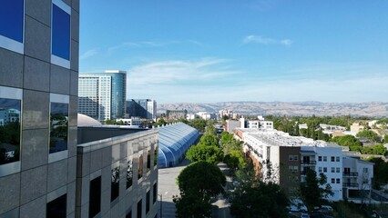 Aerial view of modern buildings in a green city on a sunny day