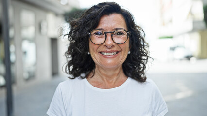 Middle age hispanic woman smiling confident standing at street