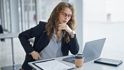Young woman business worker suffering for backache working at the office