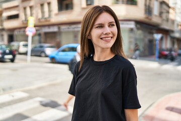 Young blonde woman smiling confident looking to the side at street