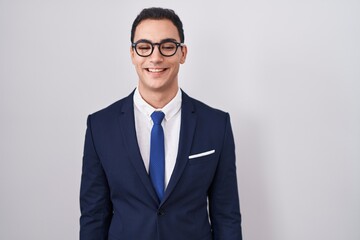 Young hispanic man wearing suit and tie with a happy and cool smile on face. lucky person.