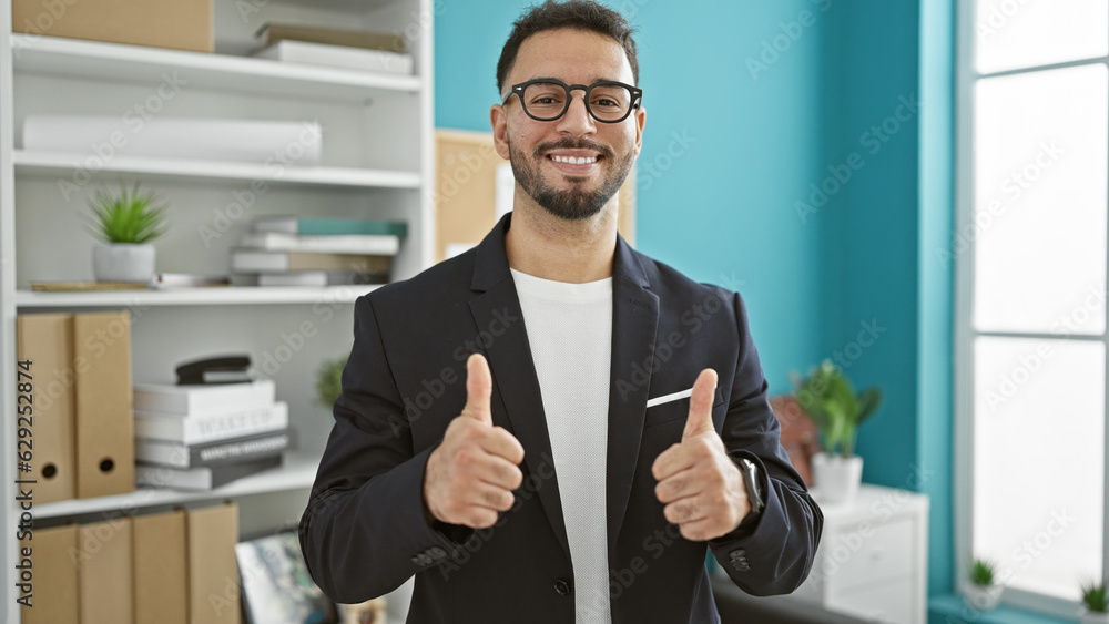 Wall mural young arab man business worker doing thumbs up gesture at the office