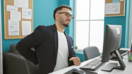 Young arab man business worker suffering for backache working at the office