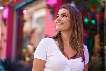 Young woman smiling confident looking to the sky at street