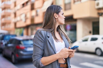 Young woman using smartphone at street