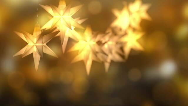 christmas star string light decoration on golden blurred bokeh light animation background, shiny xmas holiday season concept with space for text or product presentation