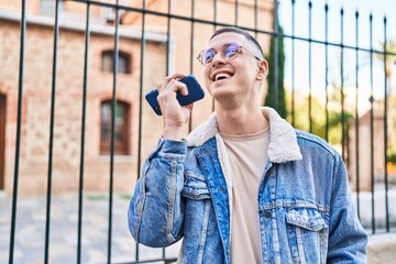 Young hispanic man smiling confident talking on the smartphone at street