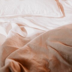 Cozy white bed with a pile of fluffy pillows and crisp white sheets