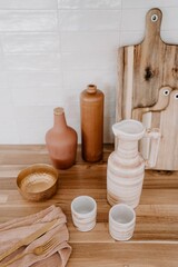 Rustic kitchen countertop with a selection of ceramic pots and bowls on display