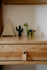 Wooden kid's table situated in a cozy room with various toys