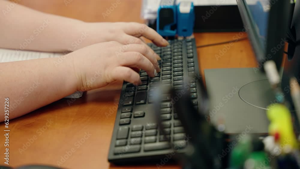 Poster closeup video of a woman working on computer using mouse and keyboard