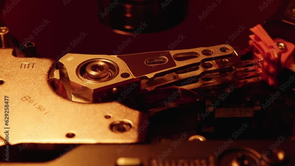 Poster closeup of the hard disk drive mechanism illuminated with red lights