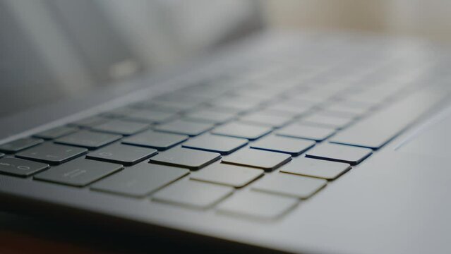 Closeup shot of a man hand typing on a keyboard.