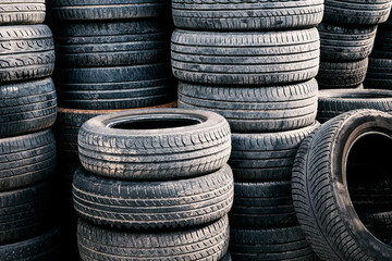 Stack of used car tires. Rubber tire dump