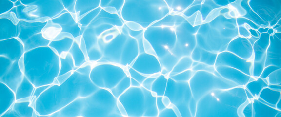 Fototapeta na wymiar Clear blue water in the pool under the rays of the sun. Banner