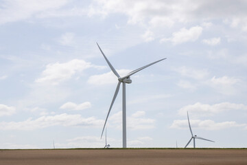 Fototapeta premium Windmills for electricity generation. Wind turbine farm, windmill farm producing green energy