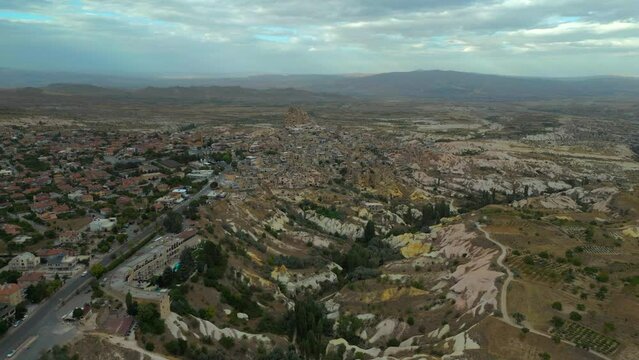 Drone view over rough landscapes and residential neighborhood in Cappadocia, Turkey