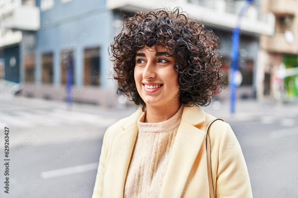 Poster Young middle east woman excutive smiling confident looking to the side at street