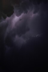 Vibrant nighttime scene of a lightning bolt streaking through the clouds