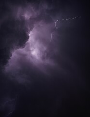 a lightning bolt breaking into the air above clouds in purple