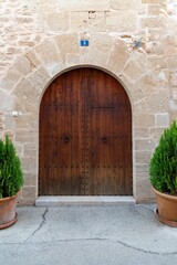 Exterior view of a traditional brown wood door, Alcudia, Spain