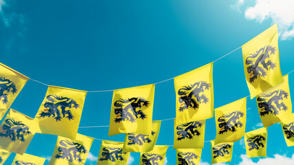Flag of Flanders - Belgium against the sky, flags hanging vertically