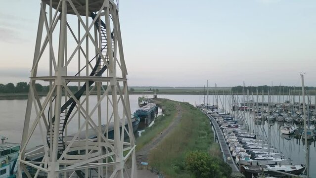 Aerial footage over a Lighthouse in Jachtmakelaardij Lemmer Nautic yachts in Lemmer, Netherlands