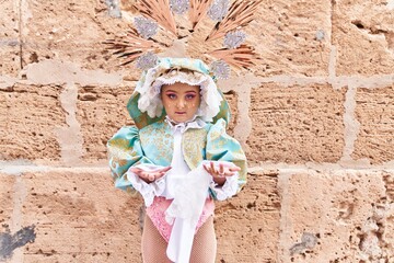 Obraz na płótnie Canvas Adorable child wearing virgion custom over brick background