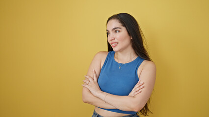 Young beautiful hispanic woman standing with arms crossed gesture saying yes with hand over...