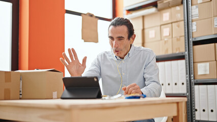 Middle age man ecommerce business worker having video call smiling at office