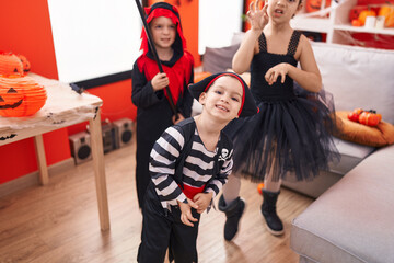 Fototapeta na wymiar Group of kids wearing costume having halloween party at home