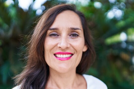 Young beautiful hispanic woman smiling confident standing at park