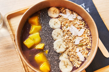  Delicious take away bowl of healthy breakfast over isolated wooden background